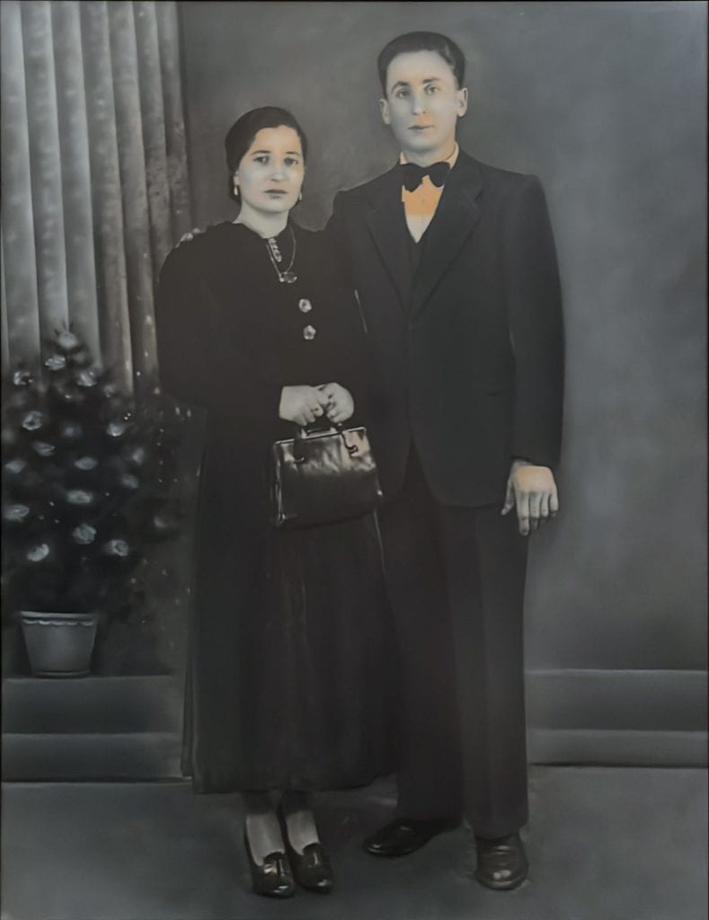 A black and white photograph of a man and a woman wearing formal clothing.