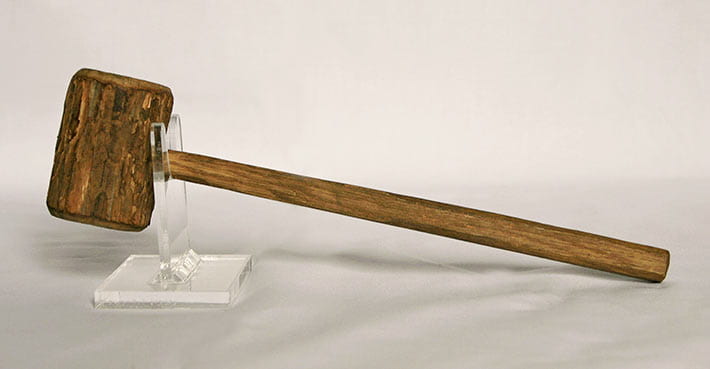 Wood mallet, made in Camp Petawawa, 1940-1942. Comprised of two to three wood pieces, including the handle, the head, and a possible plug to secure the handle to the head. Resin or glue is visible and was likely used to secure the handle to the head. The head is comprised of a small branch (2.75 inches long) with a diameter of 2 inches. The exterior bark remains in place. The mallet appears to be roughly finished. As a result, it may have had a utilitarian purpose and actually been used in wood working. This mallet is part of a group of wood objects collected and preserved by the family of internee Girolamo (George) Capponi. The mallet along with other wooden objects in the collection, may have been made by Capponi himself. He had written to his wife asking for wood-working tools.